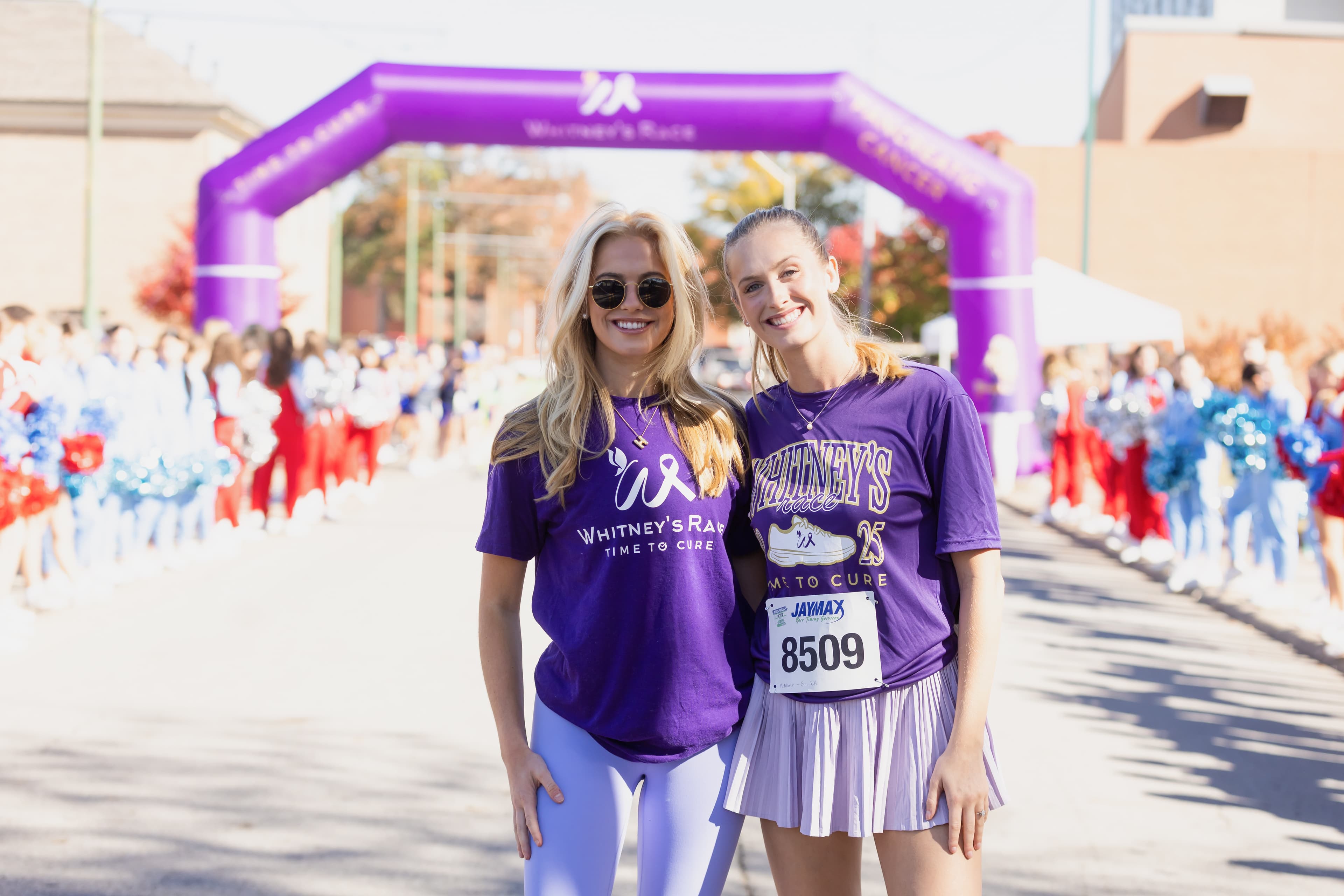 Two women at Whitney's Race 2025 celebrating at the race finish line